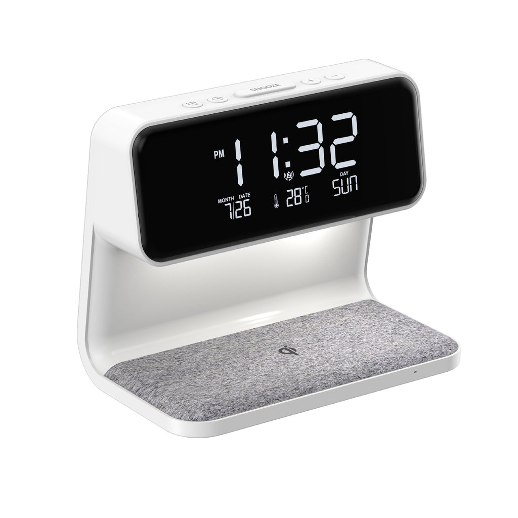 Alarm clock with white base and gray felt surface on white background.
