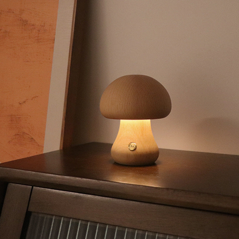 Beech mushroom-shaped table lamp on a wooden surface with warm glow.