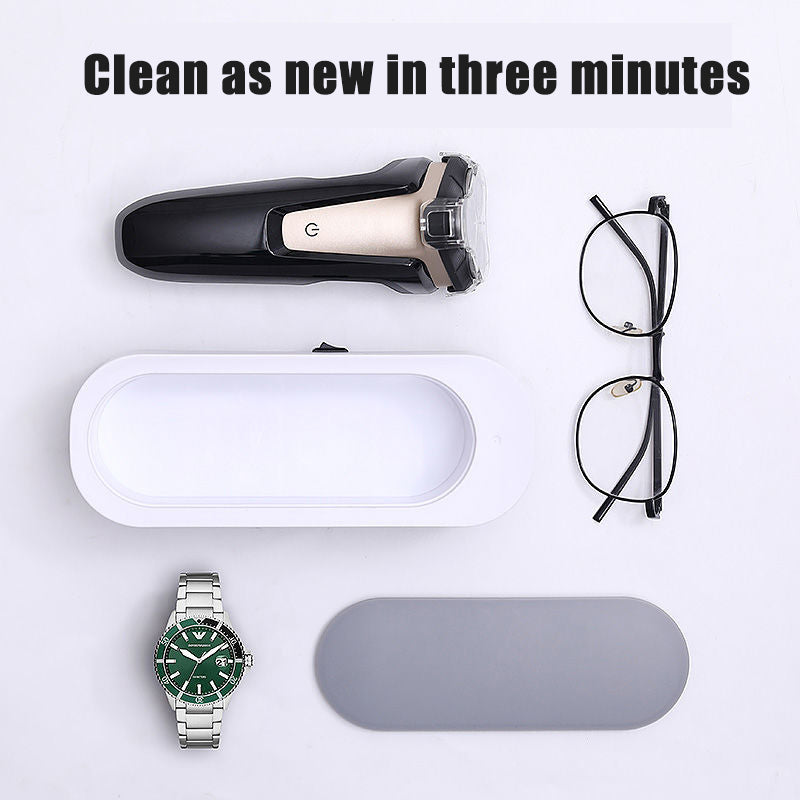 Cleaning tool with a watch, glasses and sunglasses on a white background.