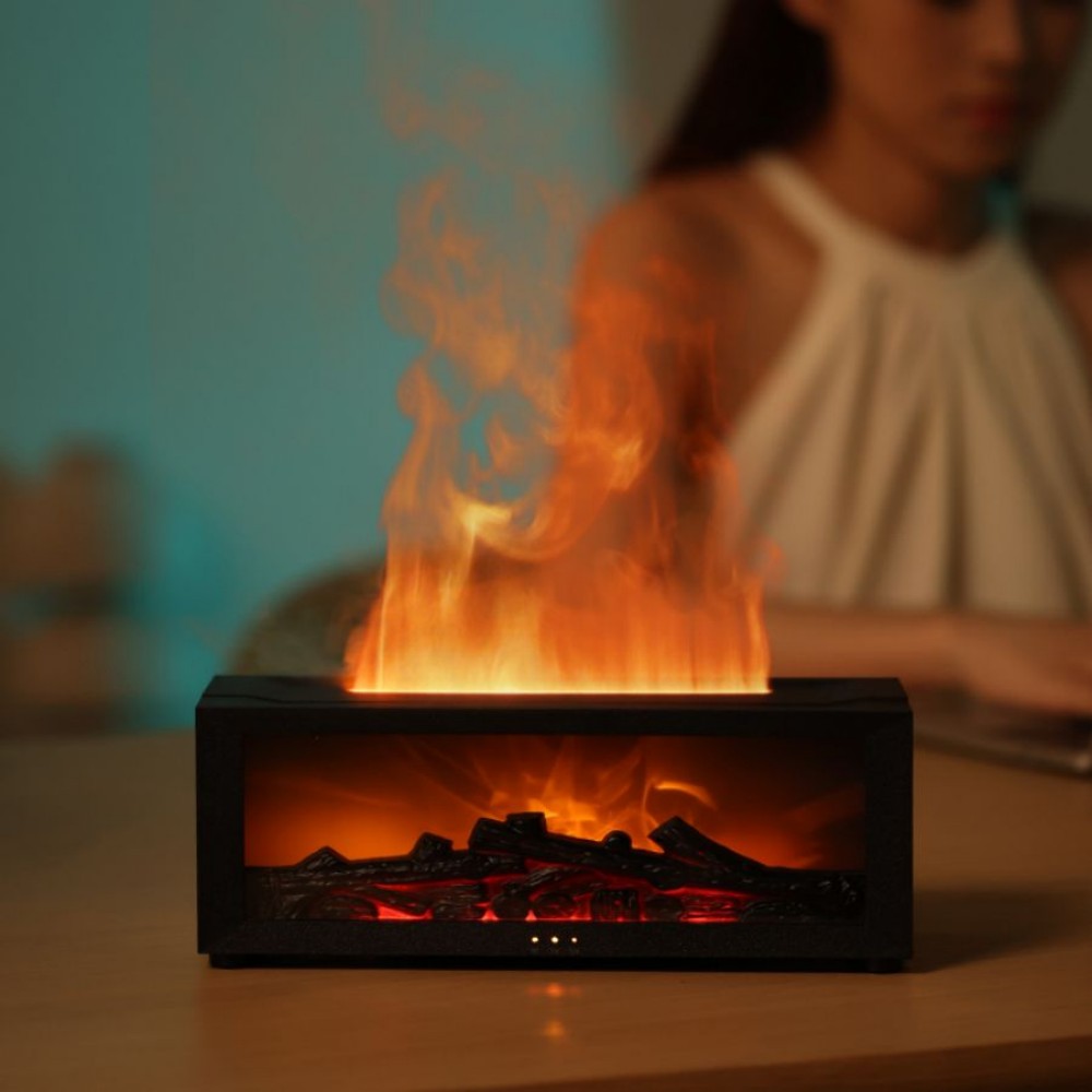 Small electric fireplace with flames on a table, blurred person in the background.