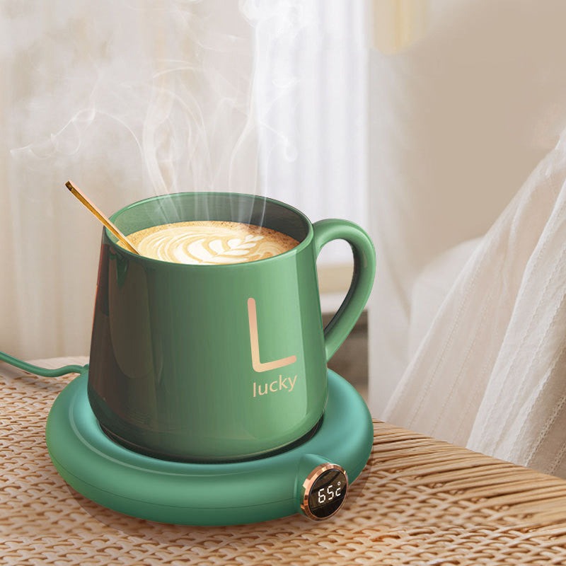 Green mug with «Lucky» on a matching hot pad, steaming coffee inside.