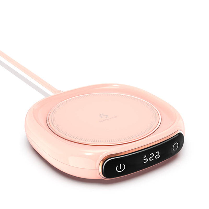Pink wireless charging pad with digital display on a white background.