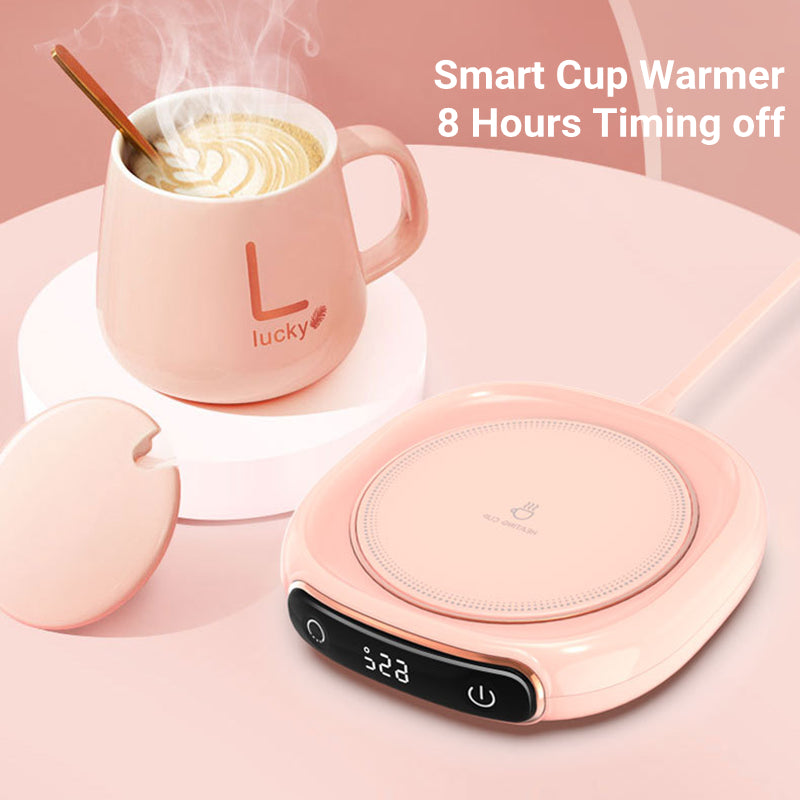 Pink smart cup warmer with a mug of steaming liquid on a pink background.
