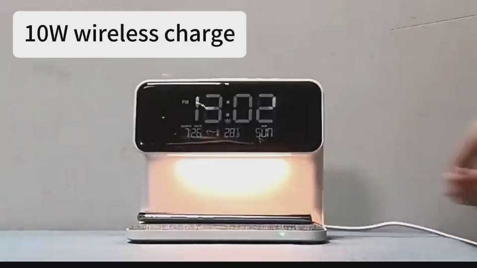 LED table lamp being demonstrated with alarm clock and phone charging functions.