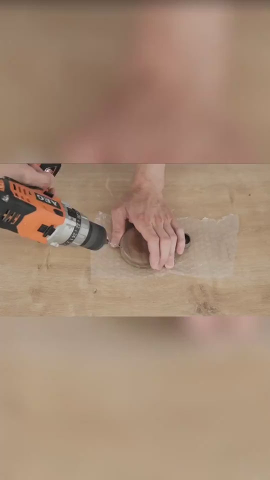 Demonstration of wooden structure with rods being built, sphere inserted and illuminated, several finished models on desk.