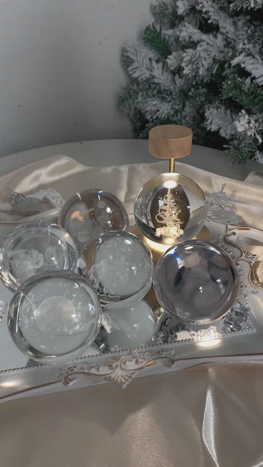 Mutiple LED light spheres on wooden stand changing lights near a Christmas tree.