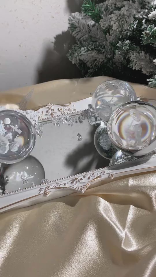 LED light spheres rolling on wooden stand and several being turned on.