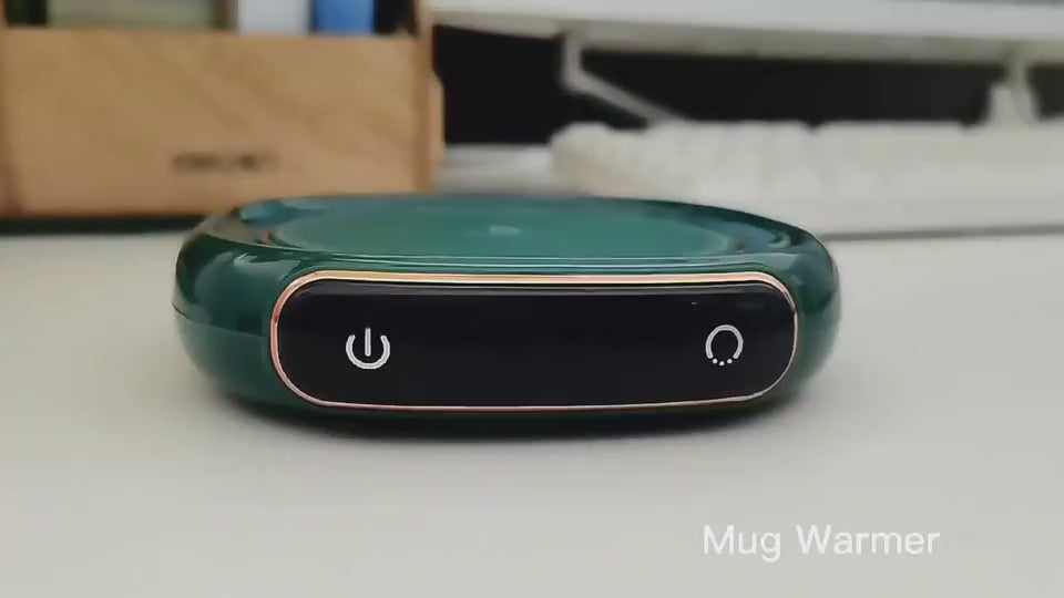 Woman using a Smart Coffee Mug Warmer at her office desk, heating tea and water in separate mugs, adjusting the temperature, and demonstrating the waterproof surface by wiping off a small spill on the warming area.