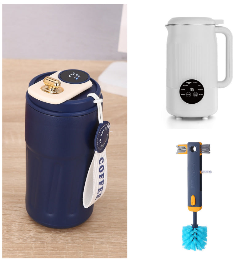Navy blue travel mug with white handle, white electric kettle, and blue cleaning brush on a light wood surface.
