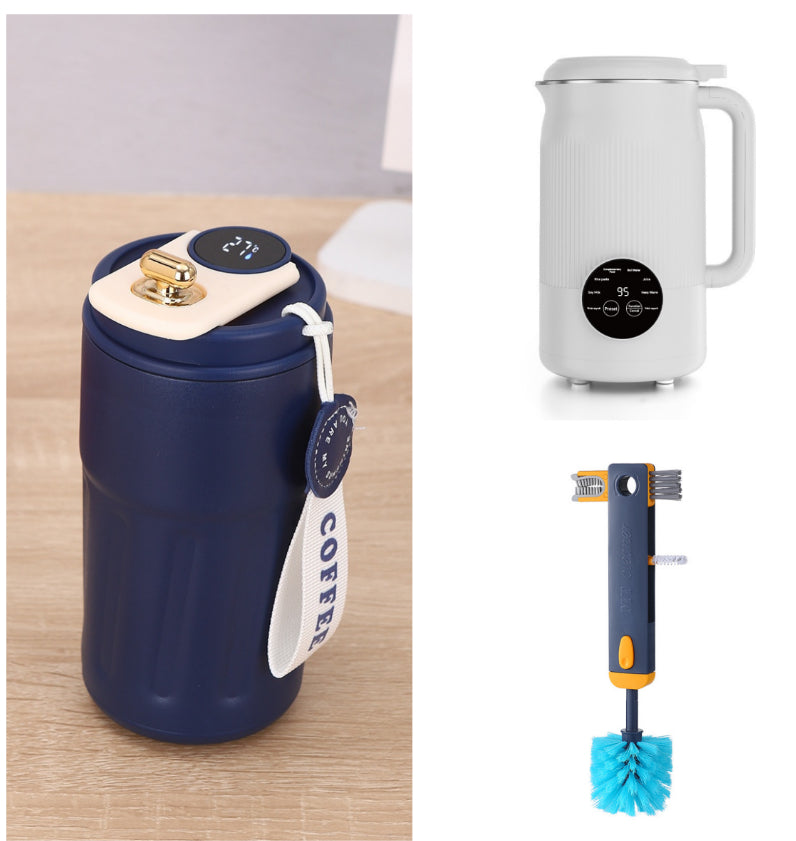 Navy blue thermos with digital display, white electric kettle, and cleaning brush on a wooden surface.